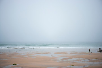 Fototapeta na wymiar misty morning at the surf beach