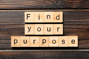 find your purpose word written on wood block. find your purpose text on table, concept
