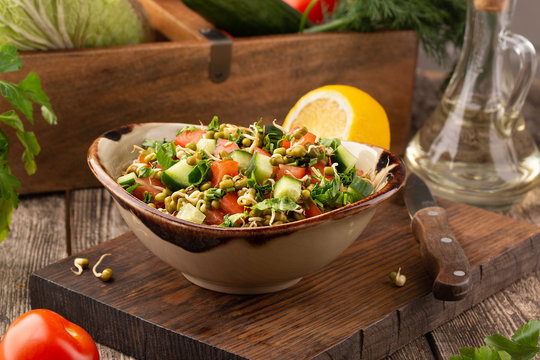 Healthy salad with mung beans, tomatoes, cucumber, lettuce and greens