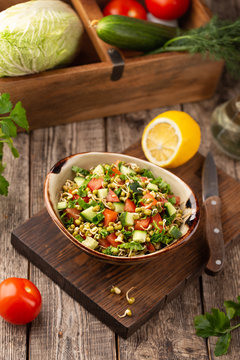 Healthy salad with mung beans, tomatoes, cucumber, lettuce and greens