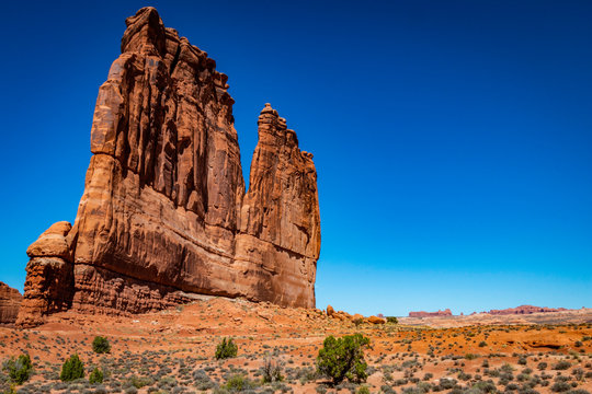 A photo showing the vast scale of The Organ monument in Arches National Park outside of Moab, Utah