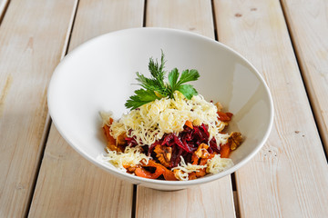 Top view of salad with beetroot, walnut, dried apricot and cheese