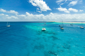 Sailing yacht anchoring in the shallow waters of suwarrow atoll, cook islands, polynesia, pacific...