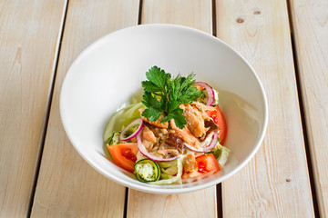 Salad with salmon, tomato, red onion and dorblu cheese