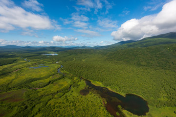aerial view of Kamchatka volcanos, green valleys, snow and ice and the wonderful view of pure nature.