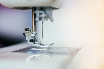 Presser foot and shuttle on the sewing machine