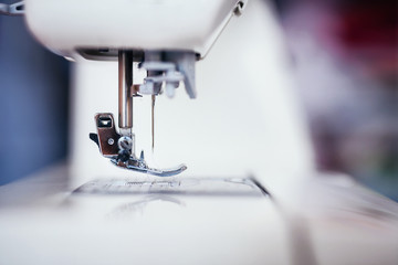 Close-up presser foot and shuttle on a sewing machine