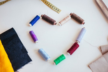 heart made of rolls of thread on a white table