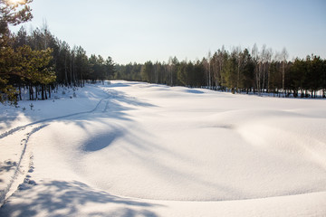 Fototapeta na wymiar great sunny day on snowy golf field