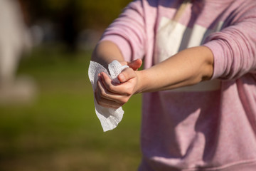 Prevention of influenza - Cleaning hands with wet wipes against disease infection like flu or influenza
