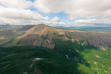 aerial view of Kamchatka volcanos, green valleys, snow and ice and the wonderful view of pure nature.