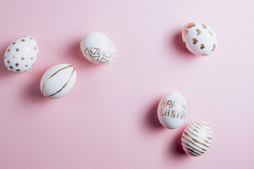 Easter eggs are hand-drawn on pink pastel background. Top view. Flat lay. Space for text. Minimalism and Happy Easter concept.