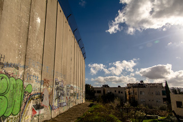 Bethlehem wall with graffiti at sunset