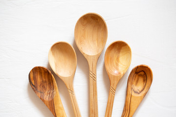 Wooden spoons made of wood on a white background. Eco-friendly dishes.