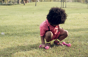 An african boy is playing in backyard