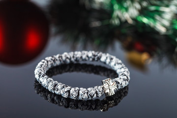 Braided bracelet made of synthetic thread. Decoration and amulet