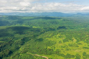 Obraz premium aerial view of Kamchatka volcanos, green valleys, snow and ice and the wonderful view of pure nature.
