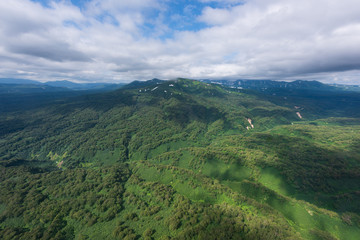 aerial view of Kamchatka volcanos, green valleys, snow and ice and the wonderful view of pure nature.