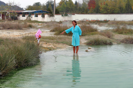 A mother with her baby bathing in the thermal area of Rupite, Bulgaria