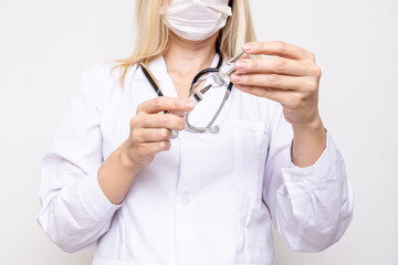 Female doctor in surgical mask filling the syringe with vaccine against coronavirus, covid-19 vaccination concept