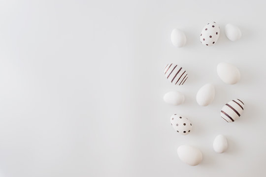 Flat lay pattern with a easter eggs on a white background