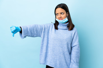 Young brunette mixed race woman protecting from the coronavirus with a mask and gloves over...