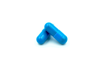 Blue pills close up on white background