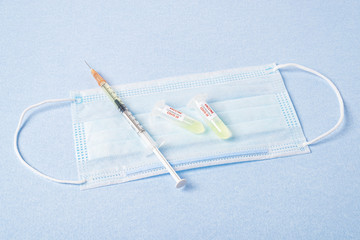Test tube with blood sample Covid-19 (coronavirus). Laboratory testing blood. Vaccine and syringe...
