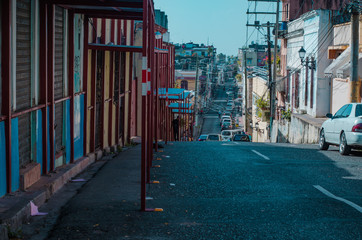 descent on a street with little traffic with businesses and a colonial touch