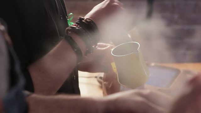 Process of making coffee or cocoa drink. Professional barista is mixing ingredients in a cup close up.