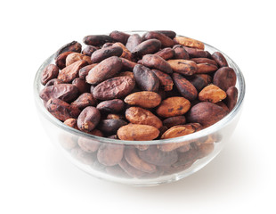 Uncooked cocoa beans in glass bowl isolated on white background with clipping path