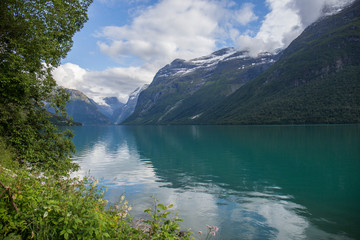 landscape of a turquoise water fjord between mountains in Norway