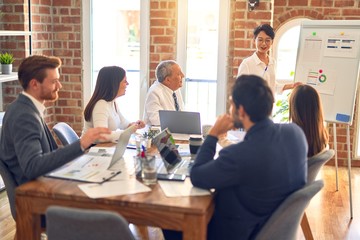 Group of business workers working together in a meeting. One of them making presentation to colleagues at the office