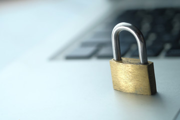 Cyber safety concept, locked and key on laptop computer keyboard.