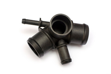 Thermostat housing. Spare part of the car engine cooling system on a white background.
