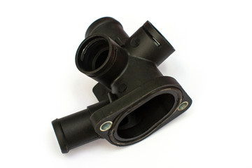 Thermostat housing. Spare part of the car engine cooling system on a white background.