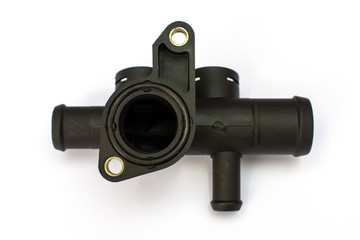 Thermostat housing. Spare part of the car engine cooling system on a white background.