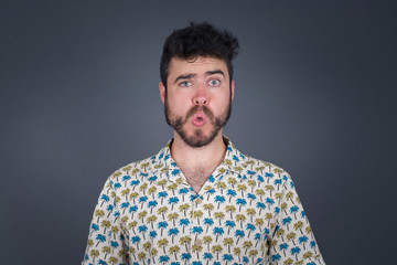 Obraz premium Brunette man in casual clothes expressing disgust, unwillingness, dislike, disregard having tensive look frowning face. Cauasian man with pleasant appearance looking indignant digusting something