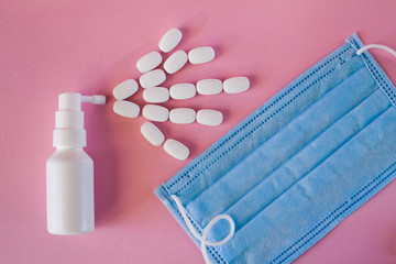 oval-shaped white tablets are sprayed from the spray, a protective mask against infection. The...