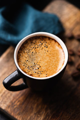 Cup of espresso coffee on wooden table closeup view