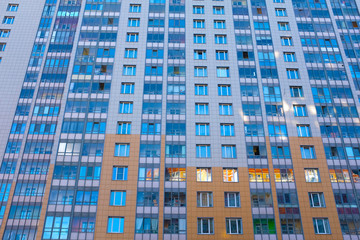 Fototapeta premium Multi-storey house with balconies in the sun