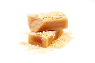 Universal antibacterial natural laundry soap. Brown bar of natural soap Isolated on a white background. Grated to dissolve in water