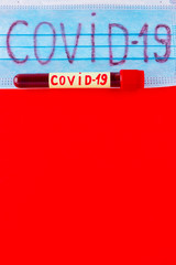 Coronavirus - COVID-19. Test tube with blood identified by the COVID-19 coronavirus on red...