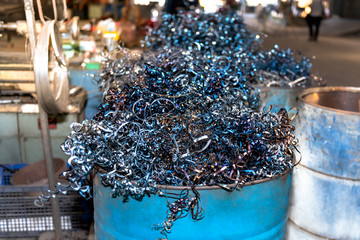 Many scrap from industrial metal ware in tanks, which can be recycled By melting new ones, concept...