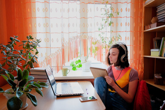Female self education online. Woman drawing in front of laptop