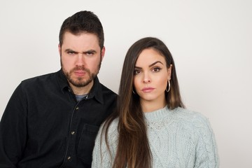 Portrait of outraged young woman with oval face, frowning her eyebrows being displeased with something.