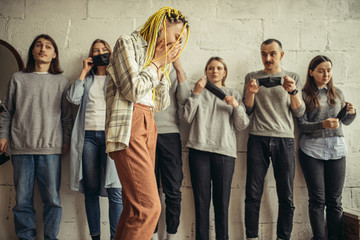 young caucasian woman found out about her illness, she cry with despair, everyone in shock from such an outcome, they wearing protective mask. coronavirus, virus, covid-19 concept