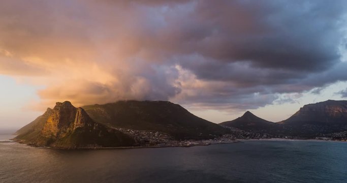 Beautiful timelapse of clouds rolling over Chapmans Peak with a beautiful bay in front
