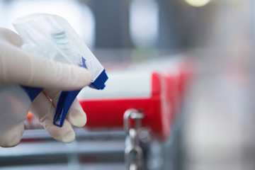 Disinfecting the handle of shopping basket. Coronavirus Epidemic Outbreak