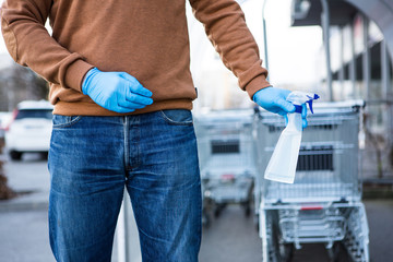 Disinfecting the handle of shopping basket. Coronavirus Epidemic Outbreak